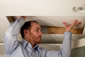 Home inspector entering an attic
